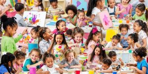 Children enjoying creative activities with colorful art supplies.